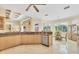 Open kitchen area shows maple cabinetry, marble flooring, and a stainless steel dishwasher at 5018 Bella Terra Dr, Venice, FL 34293