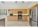 Kitchen shows stainless appliances, marble floor, window view, and maple cabinetry at 5018 Bella Terra Dr, Venice, FL 34293