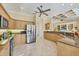 Well-lit kitchen featuring stainless steel appliances and maple cabinetry at 5018 Bella Terra Dr, Venice, FL 34293