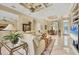 Open living space with a marble floor, stylish decor, and view into the kitchen area at 5018 Bella Terra Dr, Venice, FL 34293
