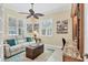 Comfortable office space with large windows, a ceiling fan, and a built in desk at 5018 Bella Terra Dr, Venice, FL 34293