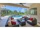 Screened patio with outdoor seating overlooking the pool and lush greenery at 5018 Bella Terra Dr, Venice, FL 34293