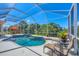 Beautiful screened-in pool with lush tropical landscaping providing privacy and relaxation at 5018 Bella Terra Dr, Venice, FL 34293