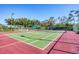 Well-maintained tennis court with lighting and verdant landscaping at 5018 Bella Terra Dr, Venice, FL 34293