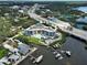 Aerial view of condo building with pool, waterfront location, marina and easy highway access; balcony unit highlighted at 516 Tamiami S Trl # 303, Nokomis, FL 34275