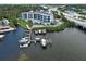 Aerial view of condo building with pool, waterfront location, marina and easy highway access at 516 Tamiami S Trl # 303, Nokomis, FL 34275