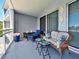Comfortable balcony seating area with river views and potted flowers at 516 Tamiami S Trl # 303, Nokomis, FL 34275