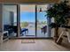 Balcony overlooks serene water view with palm trees and outdoor seating at 516 Tamiami S Trl # 303, Nokomis, FL 34275