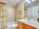 Bright bathroom featuring a shower/tub, neutral tile surround, vanity, and neutral paint at 516 Tamiami S Trl # 303, Nokomis, FL 34275