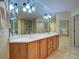 Well-lit bathroom offers double sinks, walk-in shower, and decorative wall art at 516 Tamiami S Trl # 303, Nokomis, FL 34275