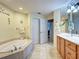Bright bathroom features a soaking tub, double closets, and light wood cabinets at 516 Tamiami S Trl # 303, Nokomis, FL 34275