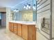 Modern bathroom with long vanity, large mirror, and heated towel rack at 516 Tamiami S Trl # 303, Nokomis, FL 34275