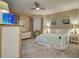 Comfortable bedroom with neutral carpet, ceiling fan, and large windows at 516 Tamiami S Trl # 303, Nokomis, FL 34275