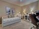 Neutral-toned bedroom with a day bed, bureau, and workstation at 516 Tamiami S Trl # 303, Nokomis, FL 34275