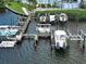 Aerial view of a private boat dock featuring multiple boat slips and well-maintained wooden piers at 516 Tamiami S Trl # 303, Nokomis, FL 34275