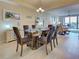 Dining room with formal seating, chandelier, and views of the outdoor balcony at 516 Tamiami S Trl # 303, Nokomis, FL 34275