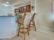 Kitchen with breakfast bar and wicker stools, stainless steel appliances, and granite counters at 516 Tamiami S Trl # 303, Nokomis, FL 34275