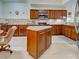 Spacious kitchen with granite island, stainless appliances, and ample cabinet space at 516 Tamiami S Trl # 303, Nokomis, FL 34275
