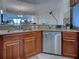 Kitchen featuring stainless steel appliances, wood cabinets, and granite countertops at 516 Tamiami S Trl # 303, Nokomis, FL 34275