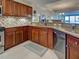 The kitchen has updated, stainless appliances, wood cabinets, and granite countertops at 516 Tamiami S Trl # 303, Nokomis, FL 34275