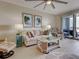 A cozy living room with comfortable seating, stylish decor, and sliding glass doors leading to a private balcony at 516 Tamiami S Trl # 303, Nokomis, FL 34275