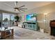 A cozy living room featuring a large flat-screen TV, stylish furniture, and sliding doors leading to a balcony at 516 Tamiami S Trl # 303, Nokomis, FL 34275