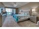 Spacious main bedroom with balcony access, coastal decor, and modern furniture at 516 Tamiami S Trl # 303, Nokomis, FL 34275