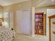 Neutral-toned bedroom with a built-in bookcase and adjacent closet at 516 Tamiami S Trl # 303, Nokomis, FL 34275