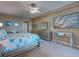 Bright main bedroom featuring mirrored accents, coastal themed decor, and a TV at 516 Tamiami S Trl # 303, Nokomis, FL 34275