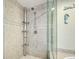 Tiled shower with mosaic accents, glass door, and modern fixtures at 516 Tamiami S Trl # 303, Nokomis, FL 34275