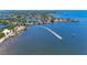Breathtaking waterfront view with a boat speeding across the shimmering water, showcasing a vibrant coastal lifestyle at 5207 5Th Avenue Nw Dr, Bradenton, FL 34209