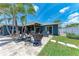 Spacious backyard with a covered patio, outdoor seating, and well-maintained lawn at 5207 5Th Avenue Nw Dr, Bradenton, FL 34209