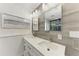 Modern bathroom with double sinks, quartz countertops, and herringbone-patterned accent wall at 5207 5Th Avenue Nw Dr, Bradenton, FL 34209