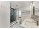 Bathroom featuring patterned tile floors, double sinks, and glass enclosed shower with subway tile and herringbone accent wall at 5207 5Th Avenue Nw Dr, Bradenton, FL 34209