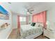 Cozy bedroom featuring a decorative bedspread, ceiling fan, and mounted TV at 5207 5Th Avenue Nw Dr, Bradenton, FL 34209