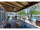 Outdoor dining area under a covered patio, with views of the pool and backyard at 5207 5Th Avenue Nw Dr, Bradenton, FL 34209