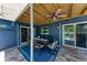 Outdoor dining area in a covered patio, featuring blue walls and tile flooring at 5207 5Th Avenue Nw Dr, Bradenton, FL 34209