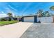 Well-kept single-Gathering home featuring a spacious driveway, two-car garage, and neat landscaping at 5207 5Th Avenue Nw Dr, Bradenton, FL 34209