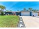 Charming single-story home with a well-manicured lawn and a two-car garage, perfect for suburban living at 5207 5Th Avenue Nw Dr, Bradenton, FL 34209