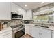 Well-appointed kitchen with stainless appliances, tiled backsplash, and natural light at 5207 5Th Avenue Nw Dr, Bradenton, FL 34209