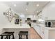 Modern kitchen featuring white cabinetry, stainless appliances, and barstool seating at 5207 5Th Avenue Nw Dr, Bradenton, FL 34209
