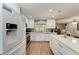 Bright kitchen with white cabinets, stainless appliances, and wood-look flooring at 5207 5Th Avenue Nw Dr, Bradenton, FL 34209
