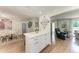 Kitchen island with seating area, leading to dining and living spaces at 5207 5Th Avenue Nw Dr, Bradenton, FL 34209