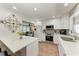 Open-concept kitchen with white cabinets, stainless appliances, and view to the living area at 5207 5Th Avenue Nw Dr, Bradenton, FL 34209