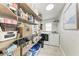 Functional laundry room with storage shelves, laundry machines, and natural light at 5207 5Th Avenue Nw Dr, Bradenton, FL 34209