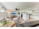 Cozy living room with hardwood floors, a ceiling fan, and an open layout with the kitchen at 5207 5Th Avenue Nw Dr, Bradenton, FL 34209