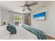 Bright main bedroom with hardwood floors, ceiling fan, and sliding glass doors to the backyard patio at 5207 5Th Avenue Nw Dr, Bradenton, FL 34209