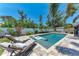 Beautiful pool with lounge chairs, surrounded by mature trees and a privacy fence at 5207 5Th Avenue Nw Dr, Bradenton, FL 34209