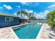 Backyard pool with lounge chairs, palm trees and patio at 5207 5Th Avenue Nw Dr, Bradenton, FL 34209