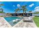Backyard pool with lounge chairs, tables, and chairs in an outdoor seating area at 5207 5Th Avenue Nw Dr, Bradenton, FL 34209